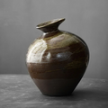 Low, rounded wabi-sabi vase with soft stone-like silhouette