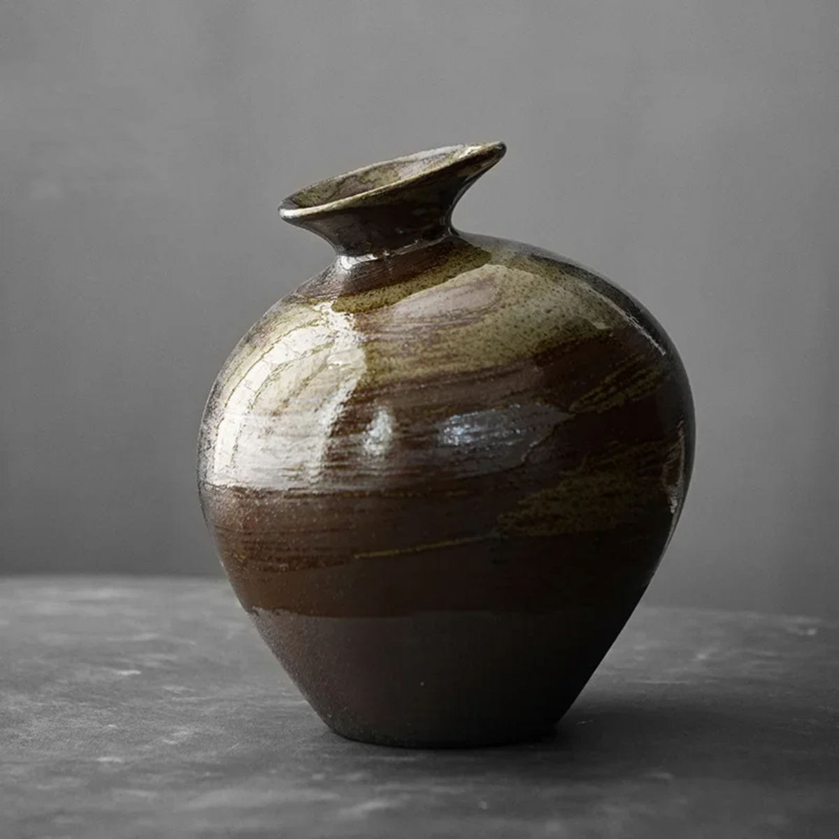 Low, rounded wabi-sabi vase with soft stone-like silhouette
