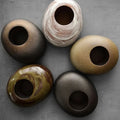 Rustic ceramic vase collection showing natural glaze variation between pieces