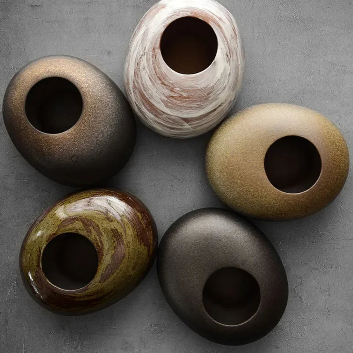 Rustic ceramic vase collection showing natural glaze variation between pieces